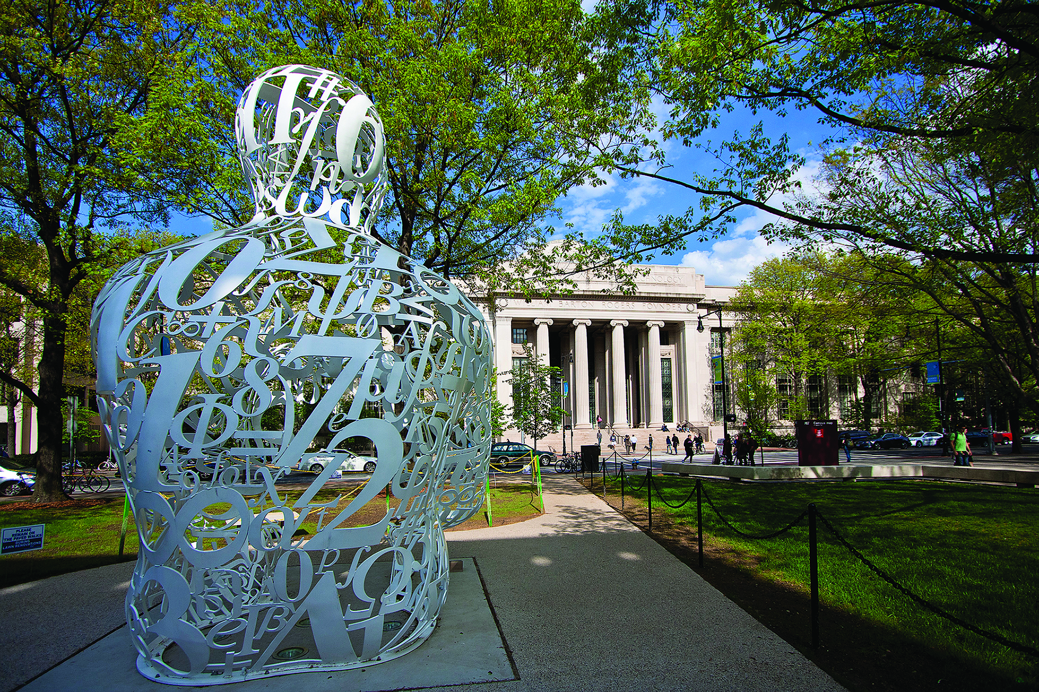 The Alchemist statue looks over the pillared Mass Ave entrance to MIT